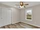 This bedroom features wood-look floors, a ceiling fan, and a large window at 2264 Walnut W St, Greenfield, IN 46140