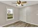 This bedroom features wood-look floors, a ceiling fan, and a large window at 2264 Walnut W St, Greenfield, IN 46140