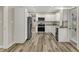 Modern kitchen features white cabinets, granite counters, stainless appliances, and luxury vinyl plank flooring at 2264 Walnut W St, Greenfield, IN 46140