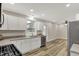 Modern kitchen with white cabinets, stainless steel appliances, and wood-look flooring at 2264 Walnut W St, Greenfield, IN 46140