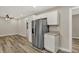 Open concept kitchen features a stainless steel fridge and luxury vinyl plank flooring at 2264 Walnut W St, Greenfield, IN 46140