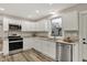Bright kitchen with stainless appliances, white cabinets, and wood-look floors at 2264 Walnut W St, Greenfield, IN 46140