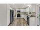 Kitchen featuring stainless appliances, white cabinetry, and wood-look flooring at 2264 Walnut W St, Greenfield, IN 46140