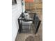 View of air conditioner condenser outside with metal cage secured around unit at 2338 N Harding St, Indianapolis, IN 46208