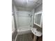 Small bathroom with a tub, shower and pedestal sink at 2338 N Harding St, Indianapolis, IN 46208