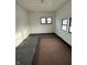 Empty room with carpet flooring, two windows and white walls at 2338 N Harding St, Indianapolis, IN 46208