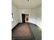 Empty room with carpet flooring, white walls, fireplace and open door at 2338 N Harding St, Indianapolis, IN 46208