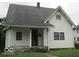 Quaint two-story home with a covered front porch and mature landscaping at 2338 N Harding St, Indianapolis, IN 46208