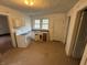 Small kitchen featuring linoleum flooring and white cabinets and appliances at 2338 N Harding St, Indianapolis, IN 46208