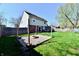 View of a backyard with a firepit, lush grass, and wooden privacy fence at 260 Christina Dr, Whiteland, IN 46184