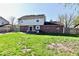 Large backyard with a view of the home, featuring lush green grass and mature trees at 260 Christina Dr, Whiteland, IN 46184