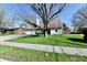 Attractive single-Gathering home with lush green lawn, mature trees, and charming architectural details at 260 Christina Dr, Whiteland, IN 46184