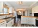 Kitchen boasts a dining area, white cabinets, stainless appliances, a farmhouse sink, and butcher block countertops at 260 Christina Dr, Whiteland, IN 46184
