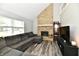 Comfortable living room with a stone fireplace, large sectional sofa, and wood-look flooring at 260 Christina Dr, Whiteland, IN 46184