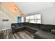 Spacious living room showcasing a blue front door, stairs, large sectional, and stylish flooring at 260 Christina Dr, Whiteland, IN 46184