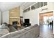 Cozy living room with stone fireplace, vaulted ceilings, and an open layout to the dining area at 260 Christina Dr, Whiteland, IN 46184