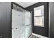 Modern shower enclosed with a frosted glass door and a window that lets natural light into the space at 260 Christina Dr, Whiteland, IN 46184