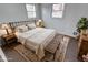 Staged bedroom features a comfortable bed, vintage furniture and decor, and large windows creating a welcoming atmosphere at 268 E Hoover Dr, Princess Lakes, IN 46164