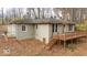 Exterior view of home, showing the wooden deck and easy access to the surrounding nature at 268 E Hoover Dr, Princess Lakes, IN 46164