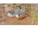 An elevated view of a single-story home featuring a wooden deck and mature trees in the backyard at 268 E Hoover Dr, Princess Lakes, IN 46164