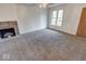 Inviting living room with a cozy fireplace, large windows and neutral carpet for comfort and natural light at 268 E Hoover Dr, Princess Lakes, IN 46164