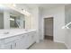 Spacious bathroom with a double vanity, tiled floors, and an open doorway to a walk-in closet at 2766 Ruffian Dr, Westfield, IN 46074