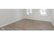 Bright bedroom featuring wood-look flooring, neutral walls and trim, and a large window allowing for ample natural light at 2766 Ruffian Dr, Westfield, IN 46074