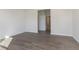 Bright bedroom featuring wood-look flooring, neutral walls and trim, with an open doorway to another room at 2766 Ruffian Dr, Westfield, IN 46074