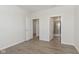Bright bedroom featuring wood-look flooring, neutral walls and trim, and an open doorway to the bathroom at 2766 Ruffian Dr, Westfield, IN 46074