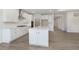Bright kitchen featuring a large island, stainless steel appliances, and hardwood floors at 2766 Ruffian Dr, Westfield, IN 46074