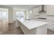 Bright kitchen features a large island with a white countertop, stainless steel appliances, and light wood-look floors at 2766 Ruffian Dr, Westfield, IN 46074