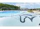 A swimming pool with an artistic design in the shallow end, surrounded by lounge chairs and shade structures at 2766 Ruffian Dr, Westfield, IN 46074