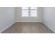 Clean, bright room with wood-look floors, neutral walls, white trim, and a large window bringing in natural light at 2766 Ruffian Dr, Westfield, IN 46074