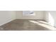 Neutral room with wood-look flooring, white trim, and a large window bringing in plenty of natural light at 2766 Ruffian Dr, Westfield, IN 46074
