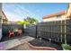 Backyard featuring a small patio set, privacy fence, rock landscaping, and mulch at 2804 Paso Del Norte Dr, Indianapolis, IN 46227