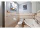 Bathroom with tiled walls, toilet, sink, and artistic decor at 2804 Paso Del Norte Dr, Indianapolis, IN 46227
