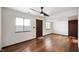 Neutral bedroom boasts wood floors, two windows letting in plenty of light, plus a ceiling fan at 2804 Paso Del Norte Dr, Indianapolis, IN 46227