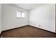 A simple bedroom with a geometrically patterned carpet, window, and standard electrical outlets at 2804 Paso Del Norte Dr, Indianapolis, IN 46227
