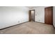 Bedroom with neutral carpet, white walls, standard electrical outlets and a dark brown wooden door at 2804 Paso Del Norte Dr, Indianapolis, IN 46227