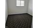 A cozy bedroom featuring patterned carpeting and a window at 2804 Paso Del Norte Dr, Indianapolis, IN 46227