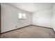 Bright bedroom features neutral carpet, white walls, a window, and simple, clean lines at 2804 Paso Del Norte Dr, Indianapolis, IN 46227
