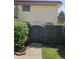 Charming townhome featuring tan siding, a brown tile roof and enclosed by a decorative black fence at 2804 Paso Del Norte Dr, Indianapolis, IN 46227