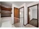 Hallway showcases wooden shelving, three doors, and carpeted floors at 2804 Paso Del Norte Dr, Indianapolis, IN 46227
