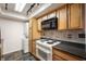This well-lit kitchen features plenty of cabinets, a microwave and stove, plus a washer/dryer combo at 2804 Paso Del Norte Dr, Indianapolis, IN 46227