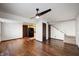 A bright living room featuring wood floors, a ceiling fan, and a staircase at 2804 Paso Del Norte Dr, Indianapolis, IN 46227