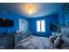 Cozy bedroom featuring bright blue walls and natural light coming in from the window at 3037 Santiago Dr, Greenwood, IN 46143