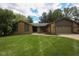 Charming single-story stone home with a well-manicured lawn and attached garage at 3037 Santiago Dr, Greenwood, IN 46143