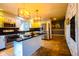 Bright kitchen with stainless steel appliances, kitchen island and stylish pendant lighting above island at 3037 Santiago Dr, Greenwood, IN 46143