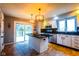 Kitchen with stainless steel appliances, island with granite counter top, and sliding glass doors to outside deck at 3037 Santiago Dr, Greenwood, IN 46143