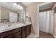 Bathroom featuring dual sinks, wood cabinets, and a large mirror at 315 Limerick Ln, Pendleton, IN 46064